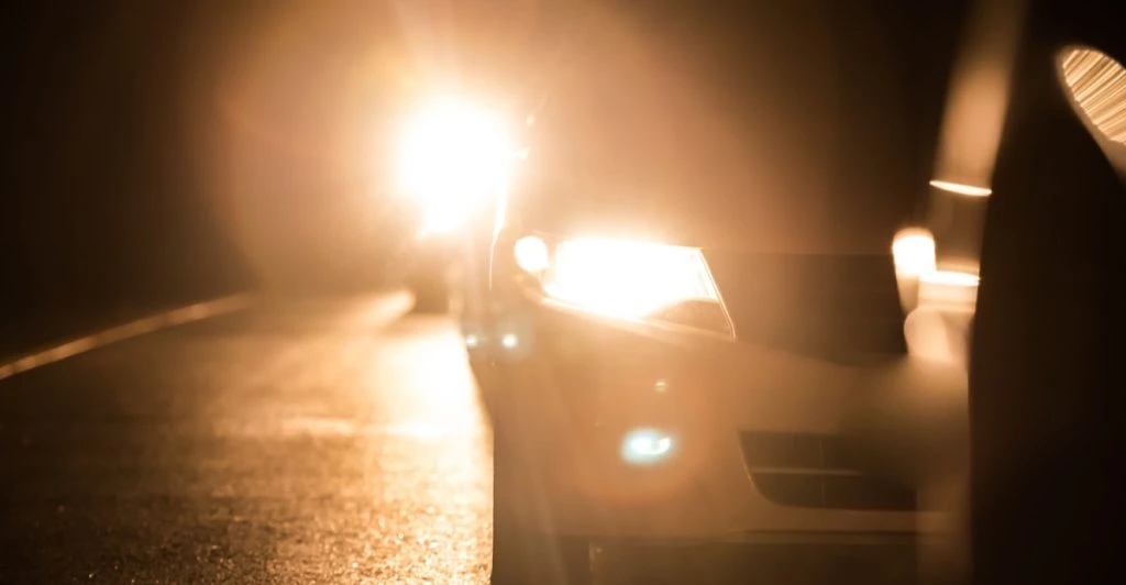 car flashing headlights at oncoming traffic