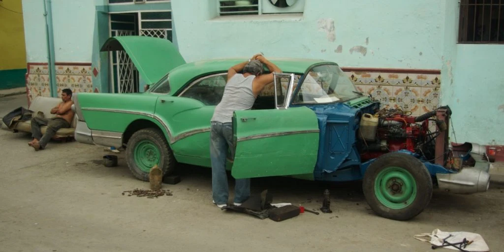 Havana, Cuba, car repair on the street.