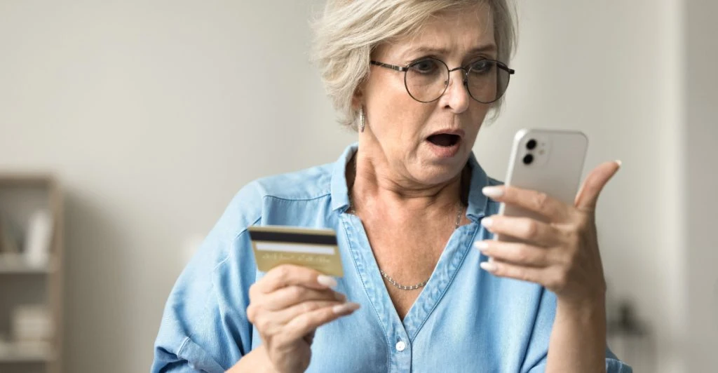 Kvinna tittar på mobilen i panik