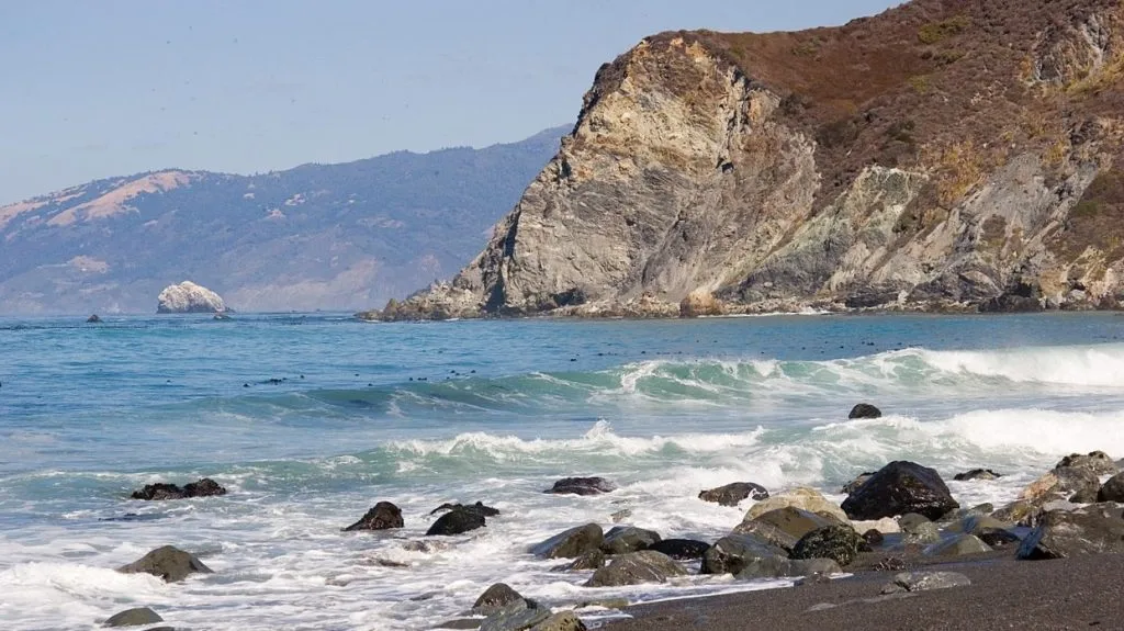 Woman rescued from cliff after being swept into dangerous waters