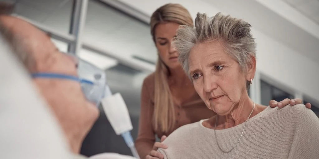 Sad family, old woman, man in bed at hospital