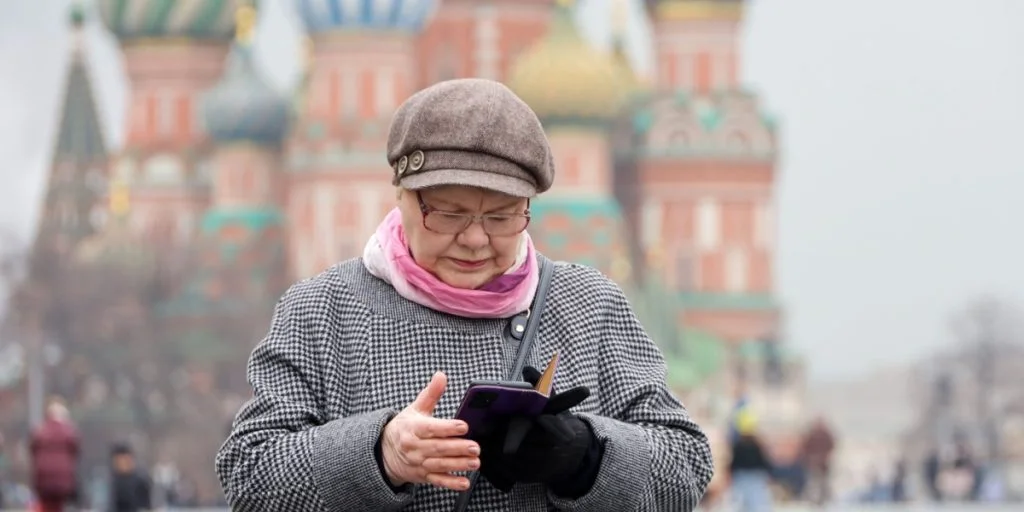 Lady red square looking at phone smartphone