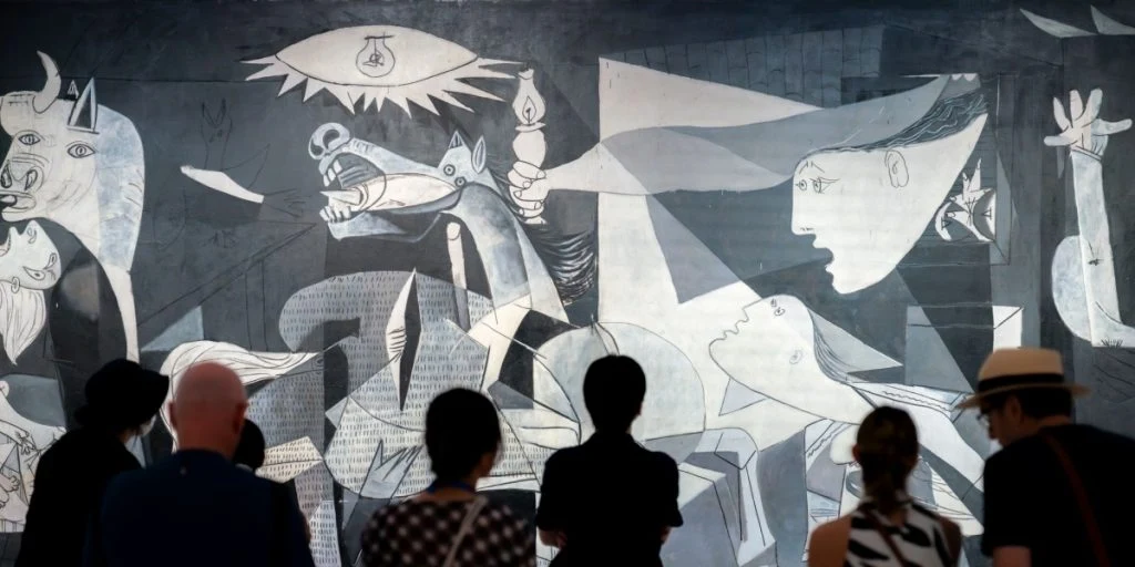 People looking at Pablo Picasso's Guernica in Museo Reina Sofía