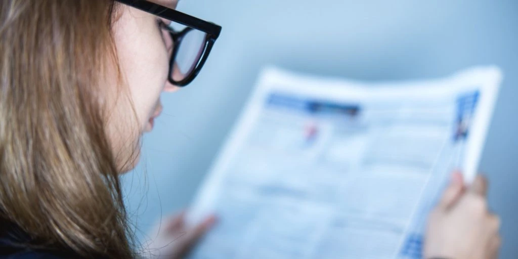 Woman reading newspaper