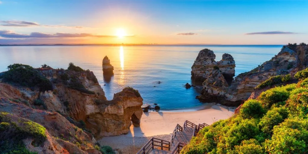 Camilo Beach (Praia do Camilo) at Algarve, Portugal with turquoise sea in the background. Wooden walkway to Praia do Camilo beach, Portugal. Wonderful view of Camilo Beach in Lagos, Algarve, Portugal.
