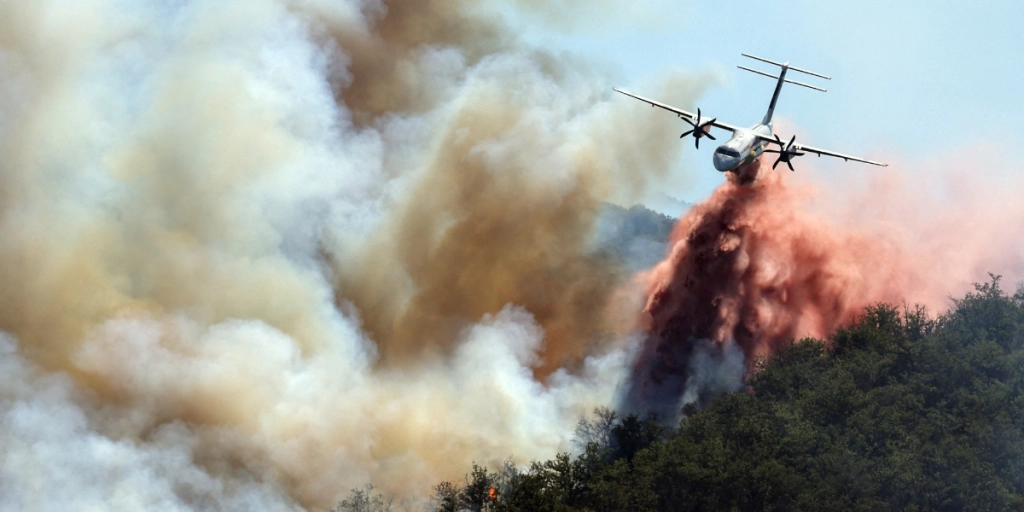 Ille-sur-Tet, France - July 8, 2026: A firefighting plane drops a massive water load over a raging wildfire near Ille-sur-Tet close to Perpignan in southern France as aerial crews work urgently to contain the devastating