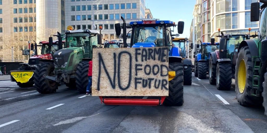 Farmers block a road with tractors near the European Parliament during a protest over price pressures, taxes and green regulation, on the day of an EU summit in Brussels, Belgium February 1, 2024.