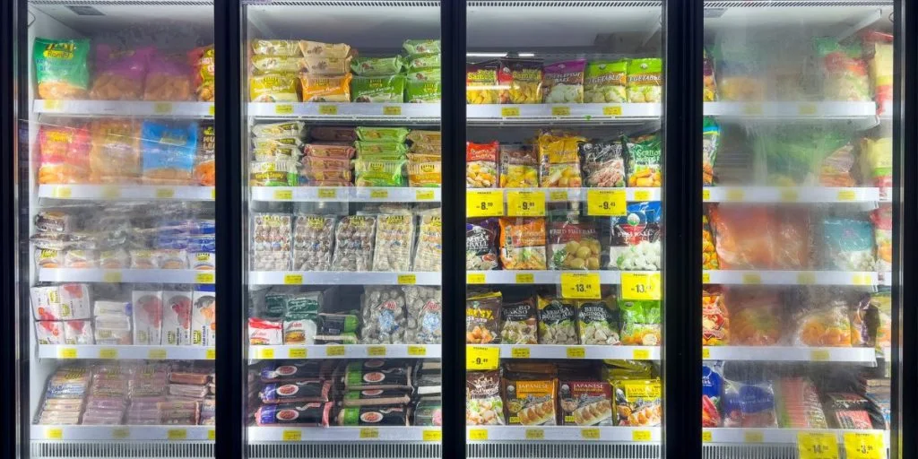 Huge glass freezer with various brands of local and imported frozen foods.