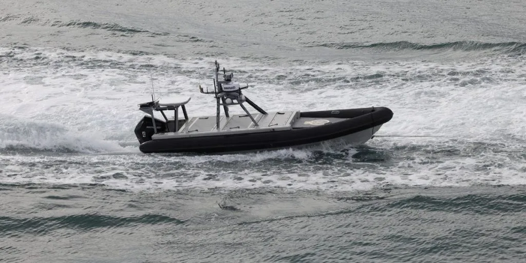 Navy Fleet Experimentation Squadron unmanned surface experiment platform RATTLER 4 is being pulled into port