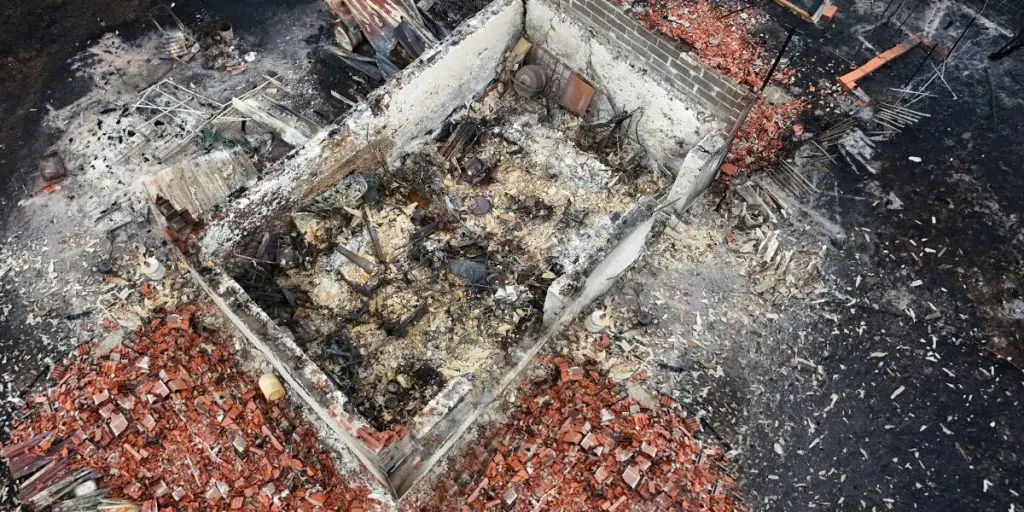 Le Porge, Gironde, France - July 29, 2026: Drone view of a burned building in an area affected by a forest fire in France.