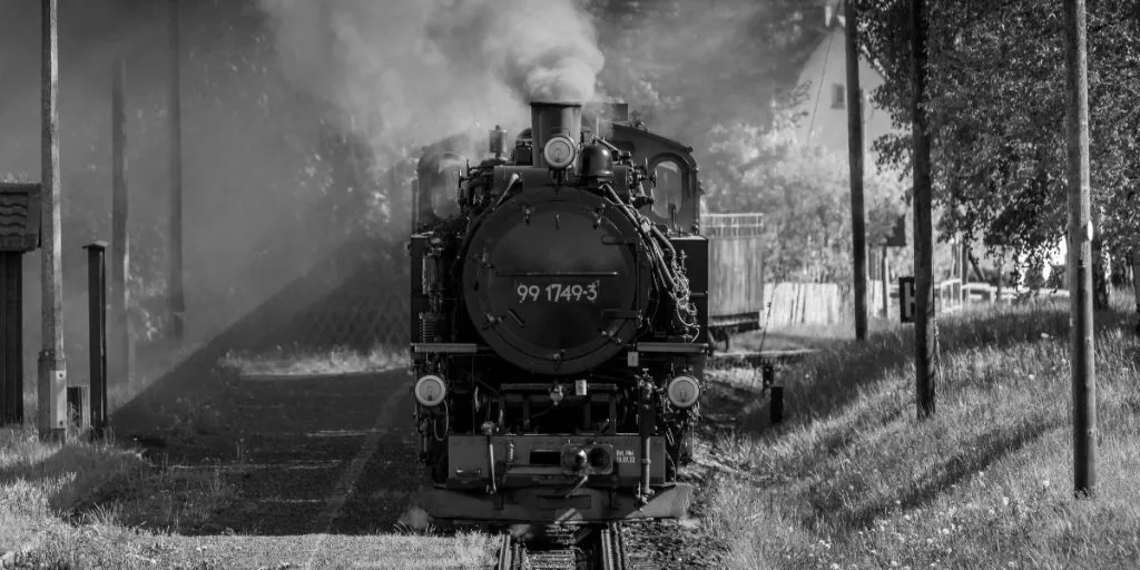 Old steam locomotive entering a station