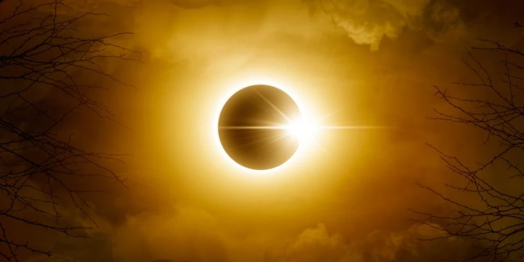 Solar eclipse. Sun behind the clouds and moon. Amazing scientific natural phenomenon.