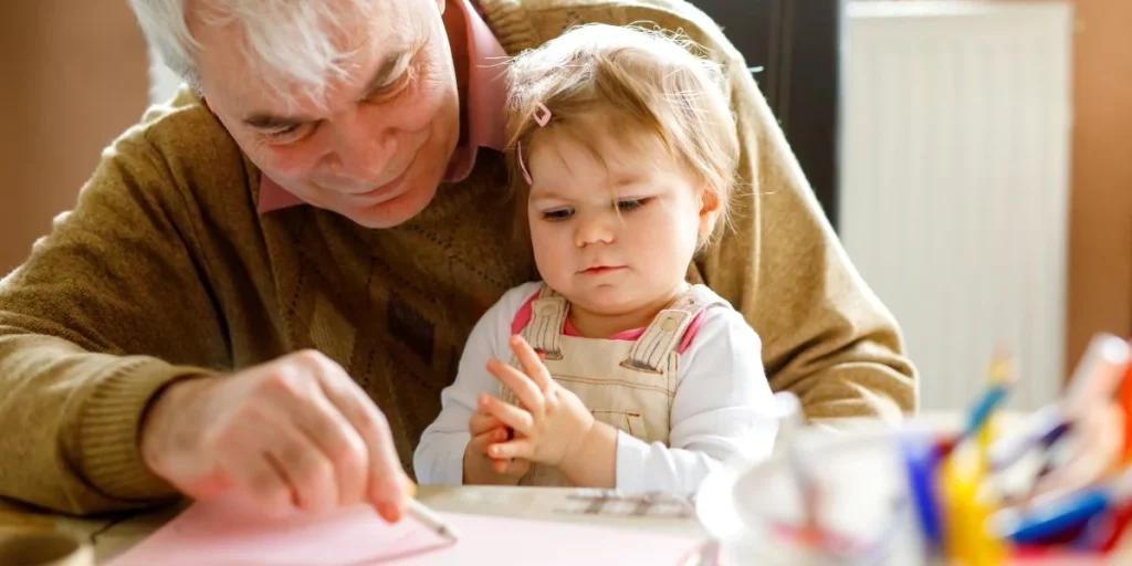 Old man taking care of little kid, baby