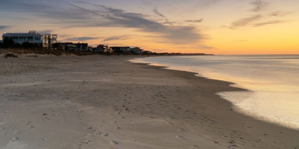View of the first row houses and endless beach on Pawleys Island at sunrise