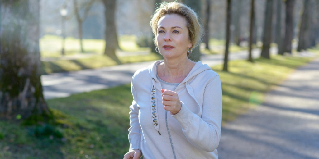 Kvinna promenerar snabbt i skogen