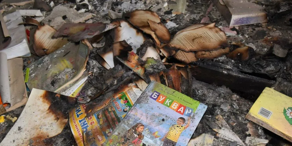 russian invasion and genocide. Ruined school, burned Ukrainian Textbooks.
